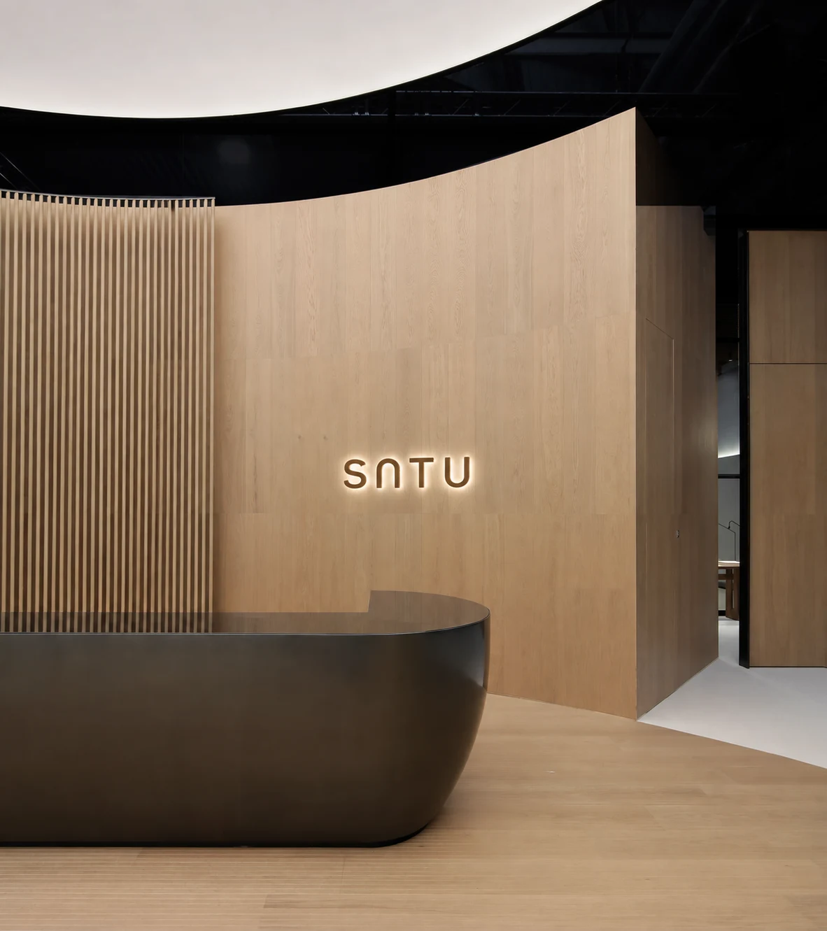 SATU reception design study with curved timber wall and dark reception desk